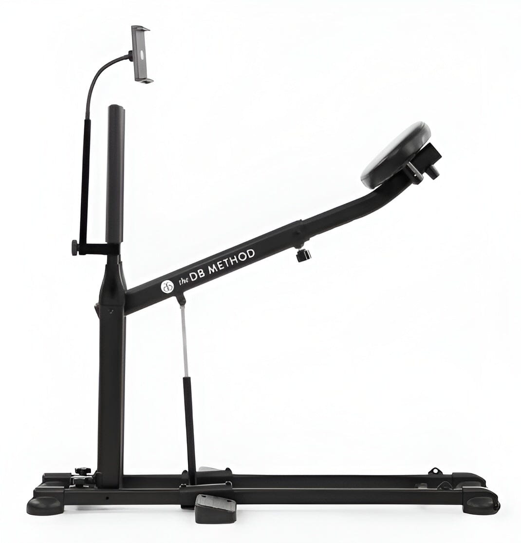 The DB Method squat machine with attached phone and tablet holder for guided home workouts.