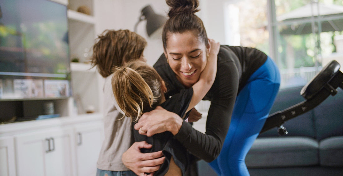 Mother hugging her children with The DB Method Machine at the back.