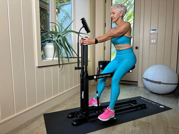 Older woman performing a controlled squat on The DB Method machine gifted on Mother’s Day.